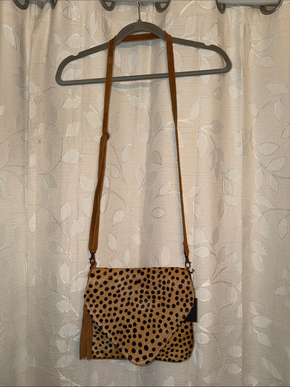 Spotted Tan Crossbody Bag with Tassel Accent